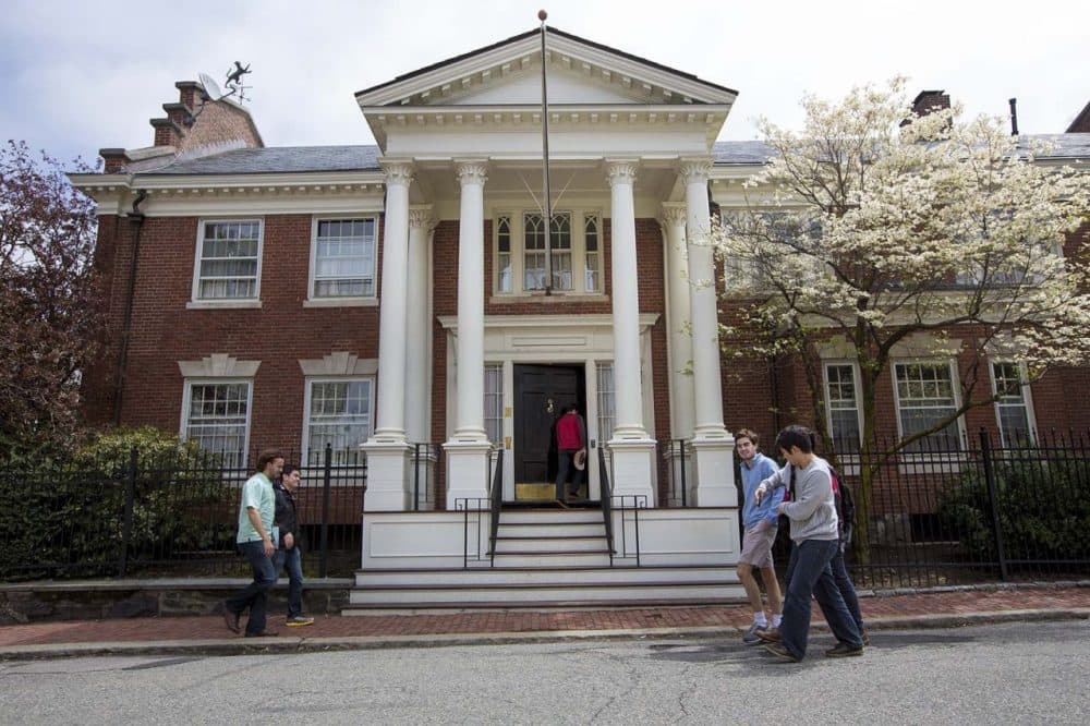 Harvard students walk by as someone enters the Fly Club a final club for male undergraduates of Harvard University.(Jesse Costa/WBUR)