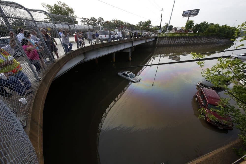 Vehicles are left stranded on a flooded Interstate 45 in Houston, Texas on May 26, 2015. Heavy rains throught Texas put the city of Houston under massive ammounts of water, closing roadways and trapping residents in their cars and buildings, according to local reports. (Aaron M. Sprecher/AFP/Getty Images)