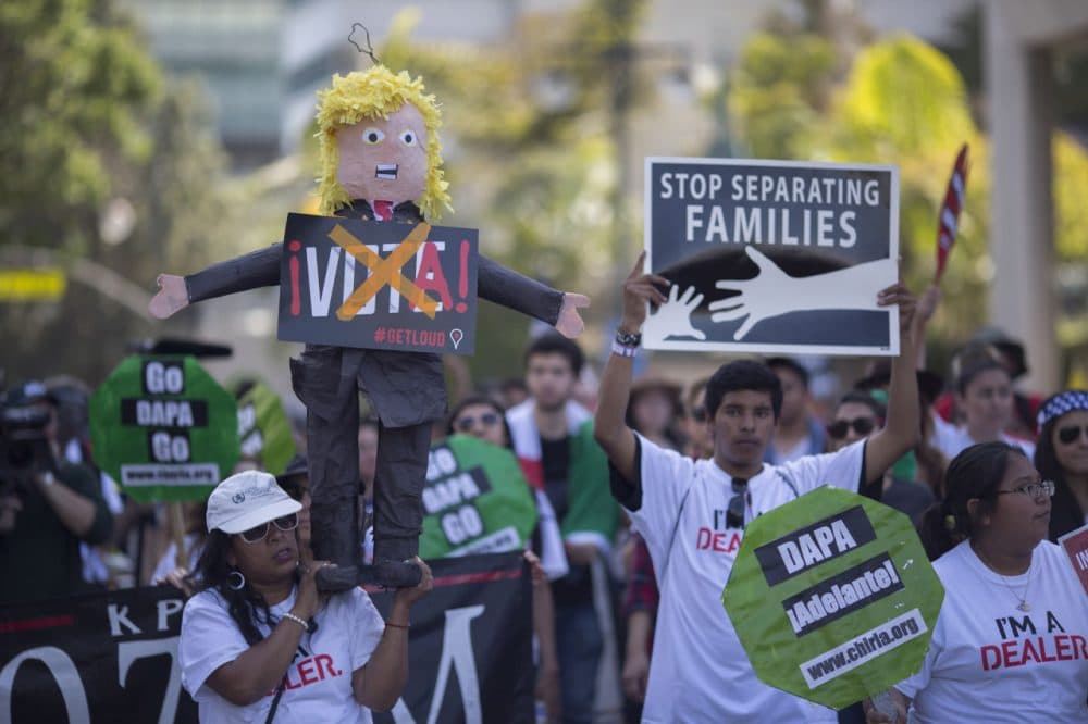 A woman carries a pinata based on Republican presidential candidate Donald Trump during one of several May Day marches on May 1, 2016 in Los Angeles, California. (David McNew/Getty Images)