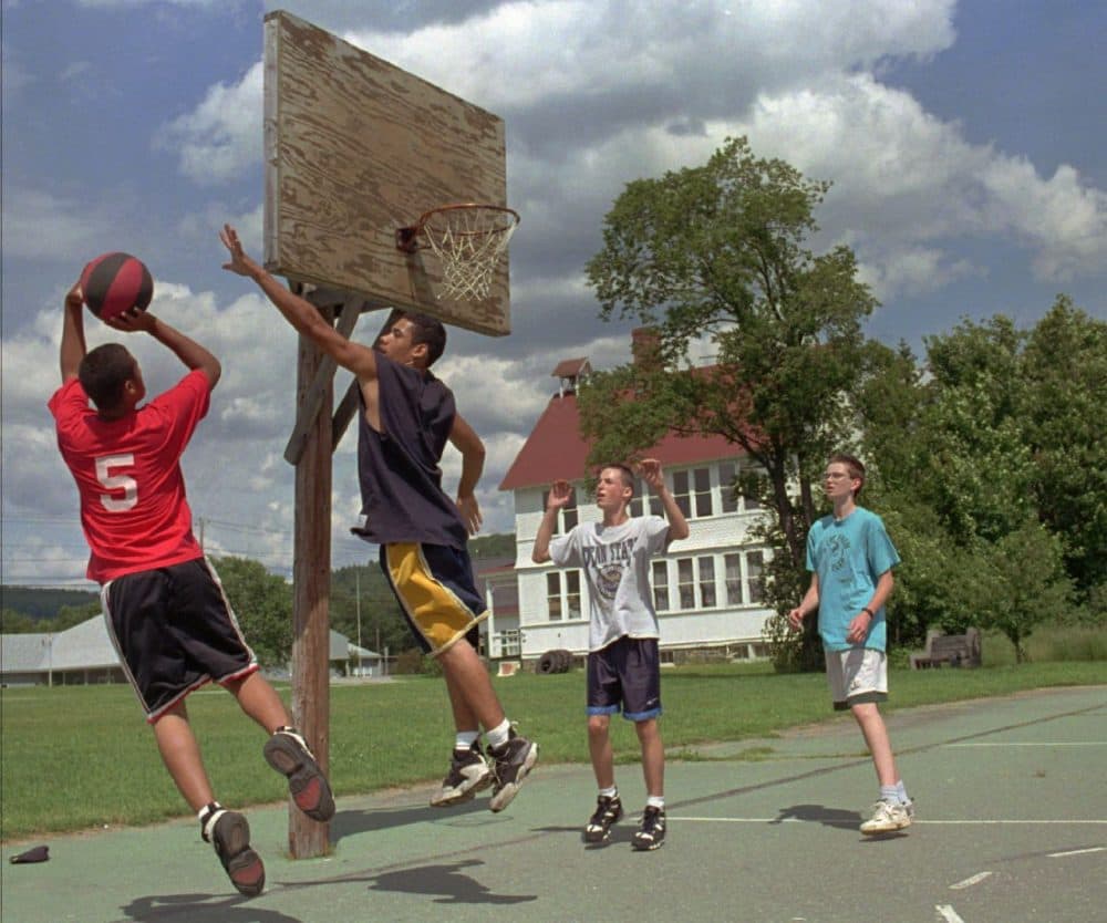 Gonzalo Ortiz, left, 16, shoots a basketball as his brother Joe Ortiz, 17, both of Brooklyn, N.Y., defends while playing in Worcester, Vt., with their Fresh Air Fund host Matt Meninger, 15, far right, and friend Patrick Harriman, 15, of East Montpelier, Vt., Friday, July 12, 1996. Gonzalo Ortiz has been coming to Vermont through the program each summer since he was four-years-old. (Craig Line/AP)