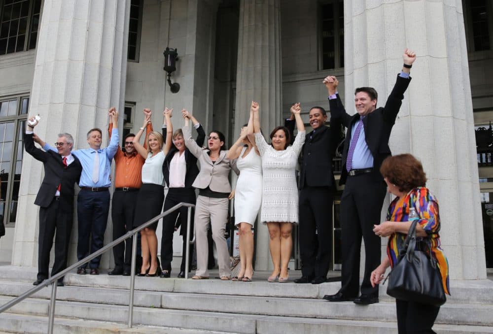 Same-sex couples and their attorneys who had previously challenged the wedding ban celebrate on court steps after Circuit Court Judge Sarah Zabel lifted the stay, allowing same-sex couples to marry January 5, 2015 in Miami, Florida. (Emily Michot-Pool/The Miami Herald/Getty Images)