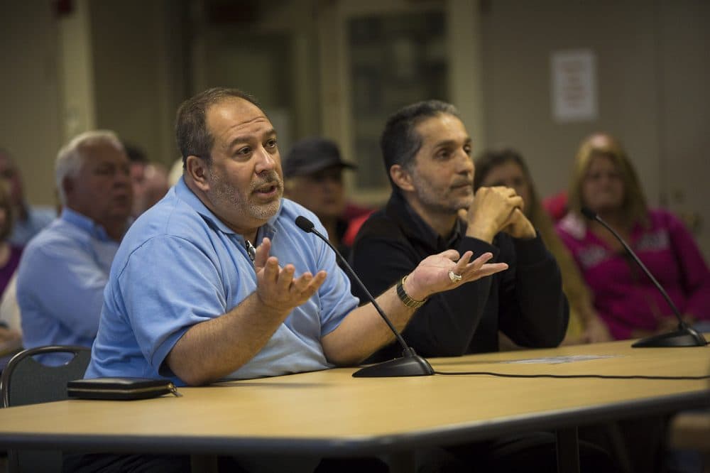 Dr. Amjad Bahnassi, left, chairman of the board of the Islamic Society of Greater Worcester, and civil engineer Imad Zrei asks questions during the Dudley Zoning Board of Appeals deliberations. (Jesse Costa/WBUR)