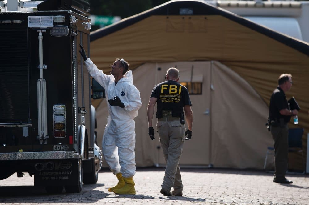 Members of the FBI and other investigators work in the area around the Pulse nightclub June 13, 2016 in Orlando, Florida.
Forty-nine people died and more than 50 were injured early June 12 when a heavily-armed gunman opened fire and seized hostages at a gay nightclub in Orlando, Florida, in the worst mass shooting in US history. (BRENDAN SMIALOWSKI/AFP/Getty Images)