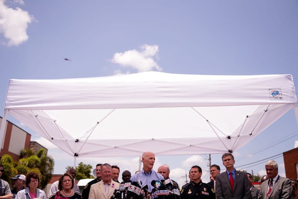 Florida Governor Rick Scott (C) speaks during a press conference updating the media on the investigation into the shooting at Pulse Nightclub, June 15, 2016 in Orlando, Florida. The shooting at Pulse Nightclub, which killed 49 people and injured 53, is the worst mass-shooting event in American history. (Drew Angerer/Getty Images)