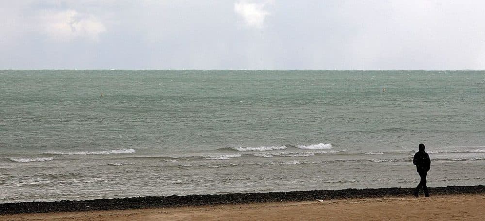 Dressed for cool weather, a man walks along Lake Michigan October 12, 2006 in Chicago, Illinois. (Tim Boyle/Getty Images)