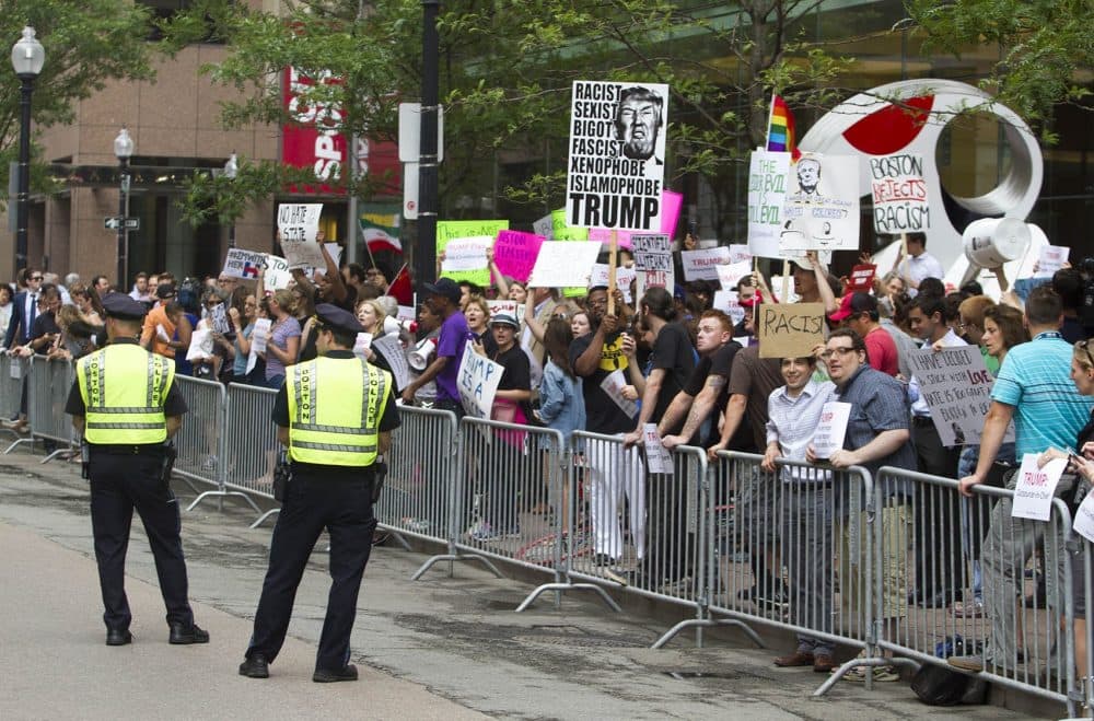 Protesters gathered outside Donald Trump's campaign fundraiser Wednesday outside The Langham hotel in downtown Boston. (Joe Difazio for WBUR)