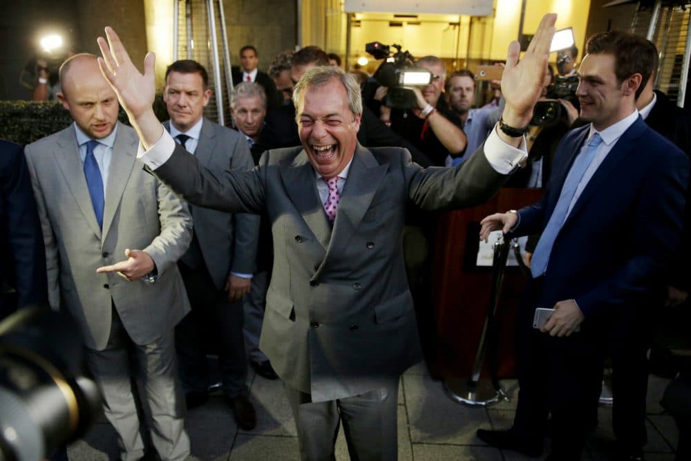Nigel Farage, the leader of the UK Independence Party celebrates and poses for photographers as he leaves a "Leave.EU" organization party for the British European Union membership referendum in London, Friday, June 24, 2016. (Matt Dunham/AP)