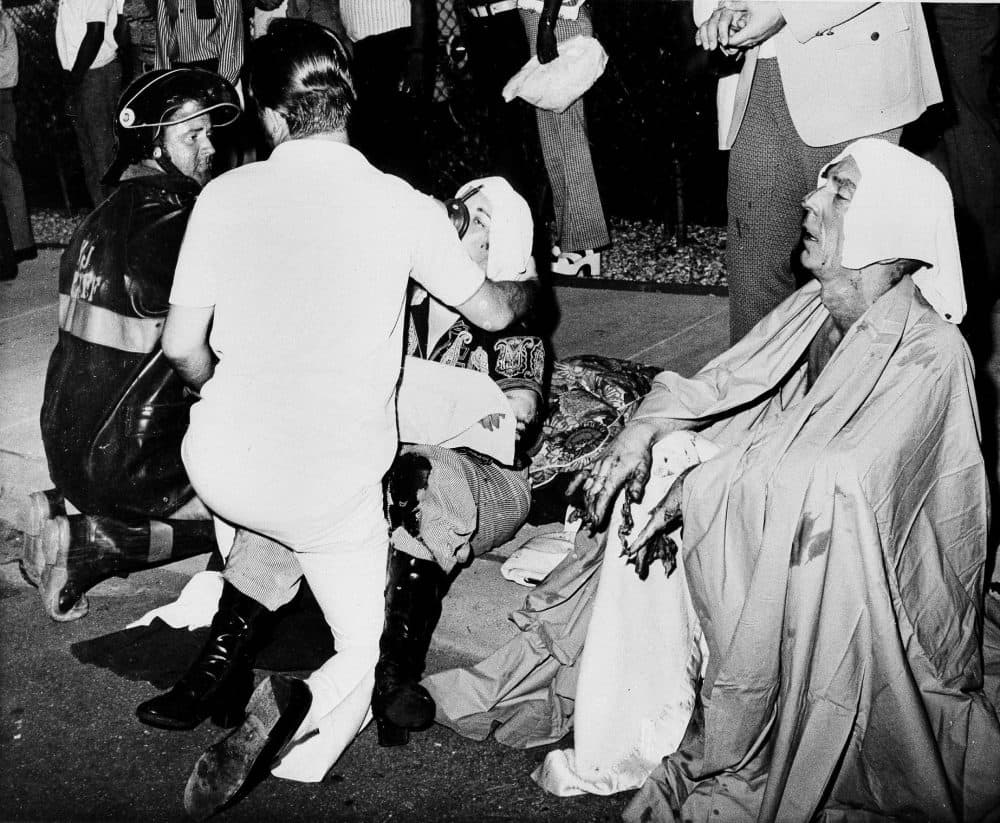 Firemen give first aid to survivors of a French Quarter fire that swept through a second story bar, June 25, 1973, in New Orleans. (G.E. Arnold/AP)