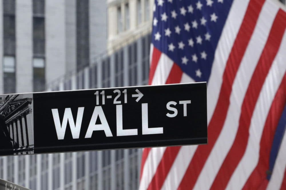 American flags fly at the New York Stock Exchange on Wall Street, Monday, July 6, 2015. (AP Photo/Mark Lennihan)