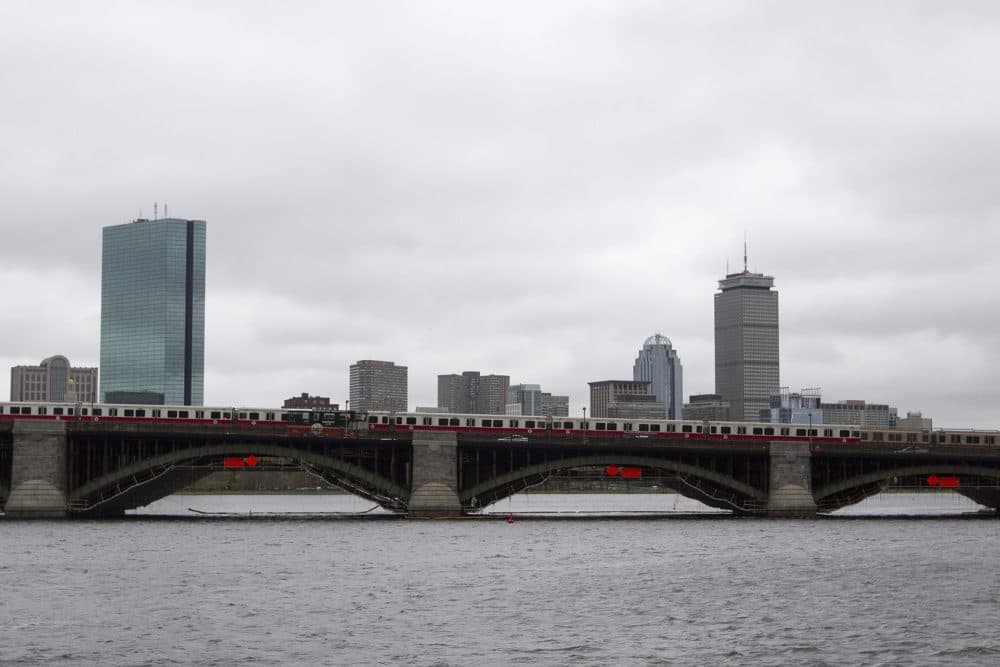 Red Line MBTA trains cross the Longfellow bridge in front of the Boston skyline. (Joe Difazio for WBUR)