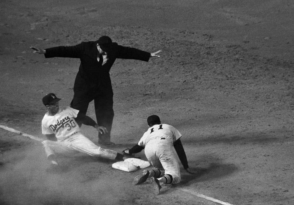 A familiar scene for Maury Wills, who was perhaps best-known for his prowess in stealing bases. (AP Photo)
