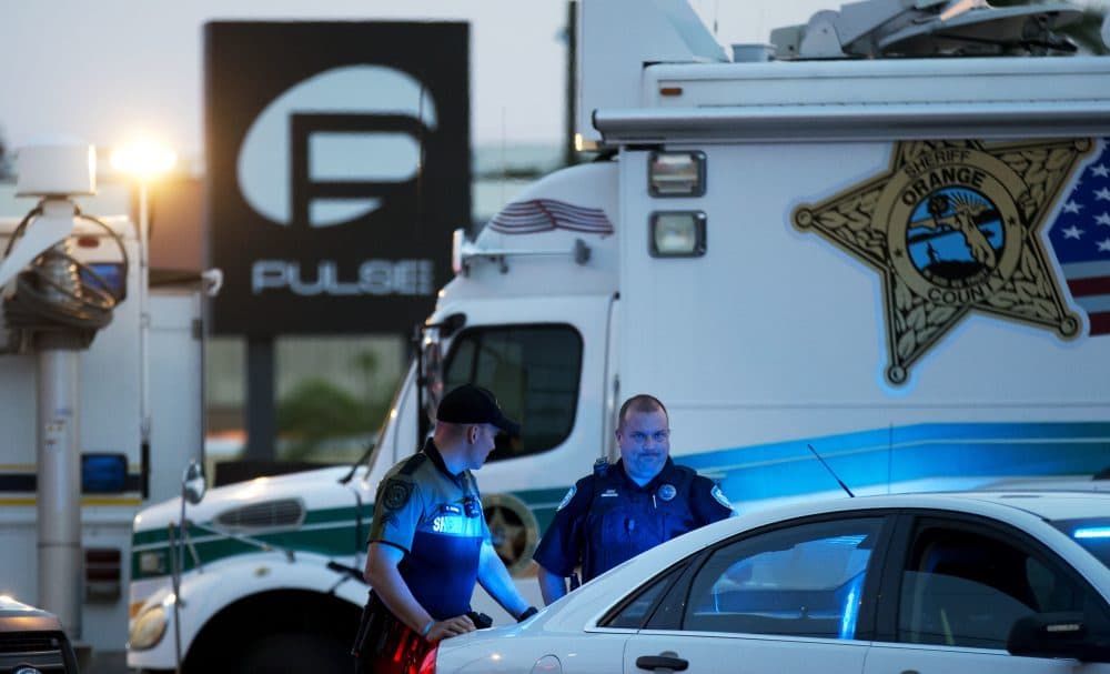 In this June 17, 2016 file photo, law enforcement officials stand outside the Pulse nightclub following the mass shooting, in Orlando, Fla. (David Goldman/AP)