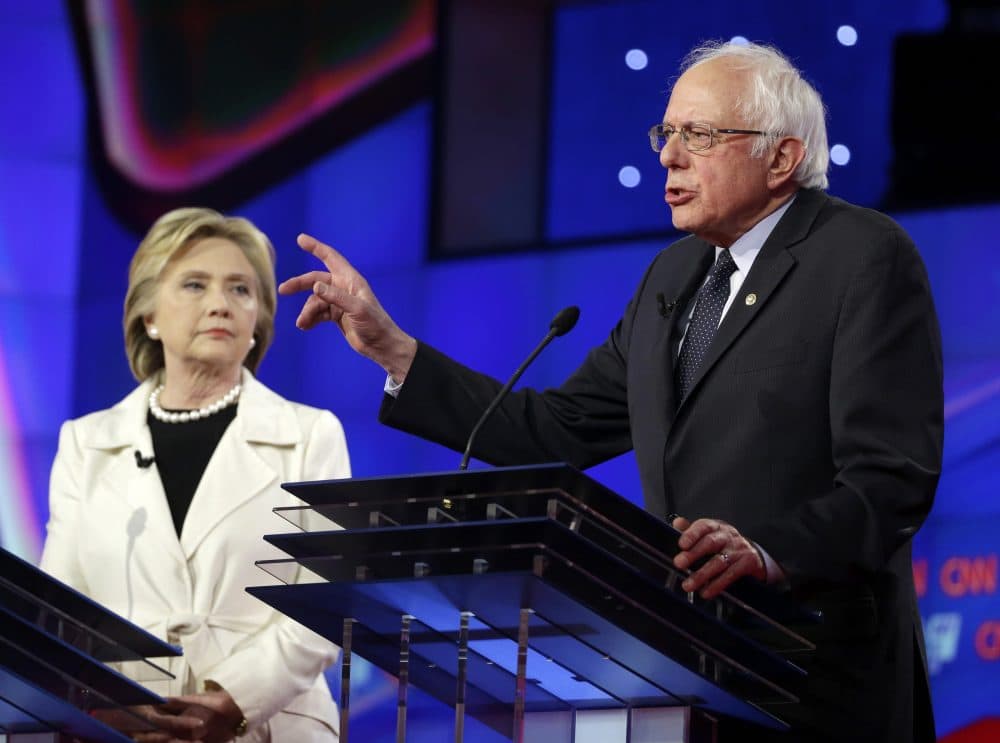 Democratic presidential candidate Sen. Bernie Sanders, I-Vt., right, speaks as Hillary Clinton listens during the CNN primary debate at the Brooklyn Navy Yard in New York. (Seth Wenig/AP)