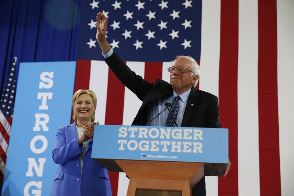 Sen. Bernie Sanders, I-Vt. waves as he a Democratic presidential candidate Hillary Clinton arrive for a rally in Portsmouth, N.H. on Tuesday. (Andrew Harnik/AP)