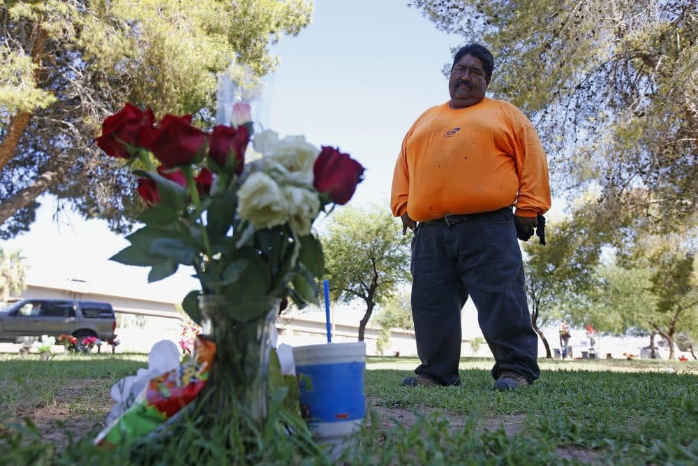 Margarito Castro, father of Manuel "Manny" Castro Garcia, 19, visits his son's grave at a cemetery Thursday, July 14, 2016, in Phoenix. The teen was killed in June, and is one of a growing number of victims associated with a serial killer according to police. (Ross D. Franklin/AP)