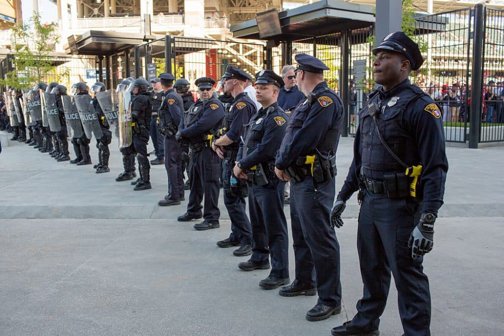 Police in front of Progressive Field stand guard during demonstrations in reaction to Cleveland police officer Michael Brelo being acquitted of manslaughter charges after he shot two people at the end of a 2012 car chase in which officers fired 137 shots May 23, 2015 in Cleveland, Ohio. (Ricky Rhodes/Getty Images)
