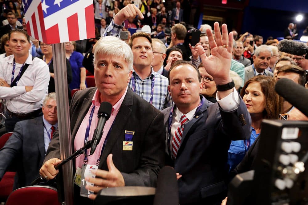 Sen. Mike Lee, (R-UT) and Phill Wright, Vice Chair of the Utah State Delegation (L) shout no to the adoption of rules without a roll call vote on the first day of the Republican National Convention on July 18, 2016 at the Quicken Loans Arena in Cleveland, Ohio. (Chip Somodevilla/Getty Images)