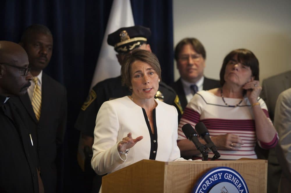 Surrounded by police, district attorneys and clergy, Attorney General Maura Healey announces new enforcement of Massachusetts’ assault weapon ban on July, 20, 2016. (Joe Difazio for WBUR)