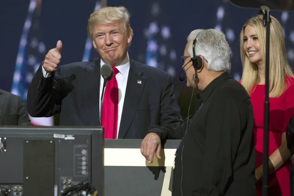 Republican presidential candidate Donald Trump, center, gives a thumbs up as he talks with production crew during a walk through in preparation for his speech at the Republican National Convention, Thursday, July 21, 2016, in Cleveland. At right is his daughter Ivanka. (Evan Vucci/AP)