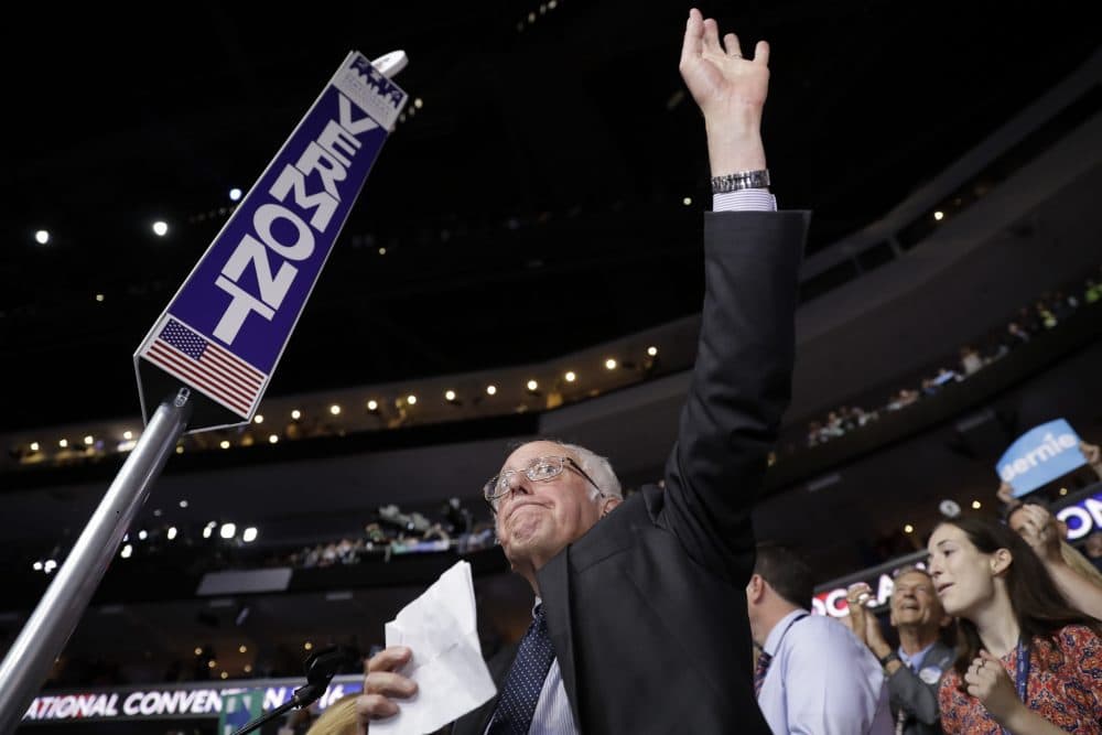 Sen. Bernie Sanders waves Tuesday evening from the floor of the DNC before asking delegates to accept Hillary Clinton's nomination unanimously and by acclimation.
(Matt Rourke/AP)