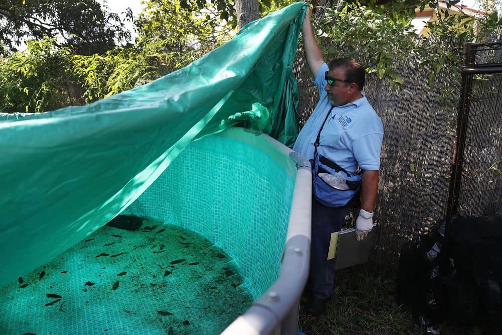 Robert Muxo, a Miami-Dade County mosquito control inspector, inspects a property for mosquitos or breeding areas in the Wynwood neighborhood as the county fights to control the Zika virus outbreak on July 30, 2016 in Miami, Florida. (Joe Raedle/Getty Images)