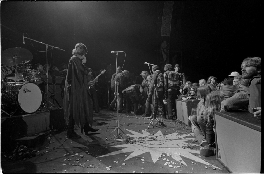 Mick Jagger covers his face as the body of Meredith Hunter is pushed from the stage at the Altamont Free Concert at Altamont Speedway, California on Dec. 6, 1969. Hunter was stabbed to death, allegedly by a Hells Angel. (Courtesy of Beth Bagby)