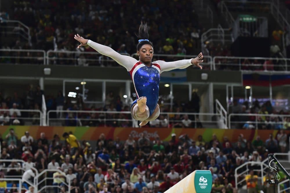 Simone Biles won gold in both the team and individual all-around. (Emmanuel Dunnand/AFP/Getty Images)