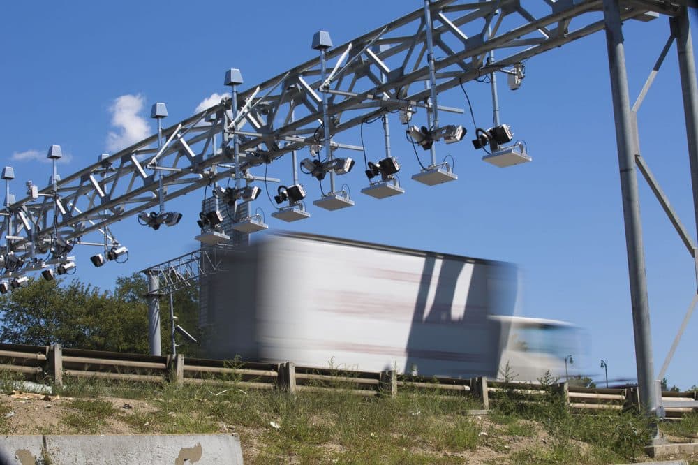 A truck passes under the toll gantry on the Massachusetts Turnpike at the Commonwealth Avenue overpass in Boston. (Jesse Costa/WBUR)