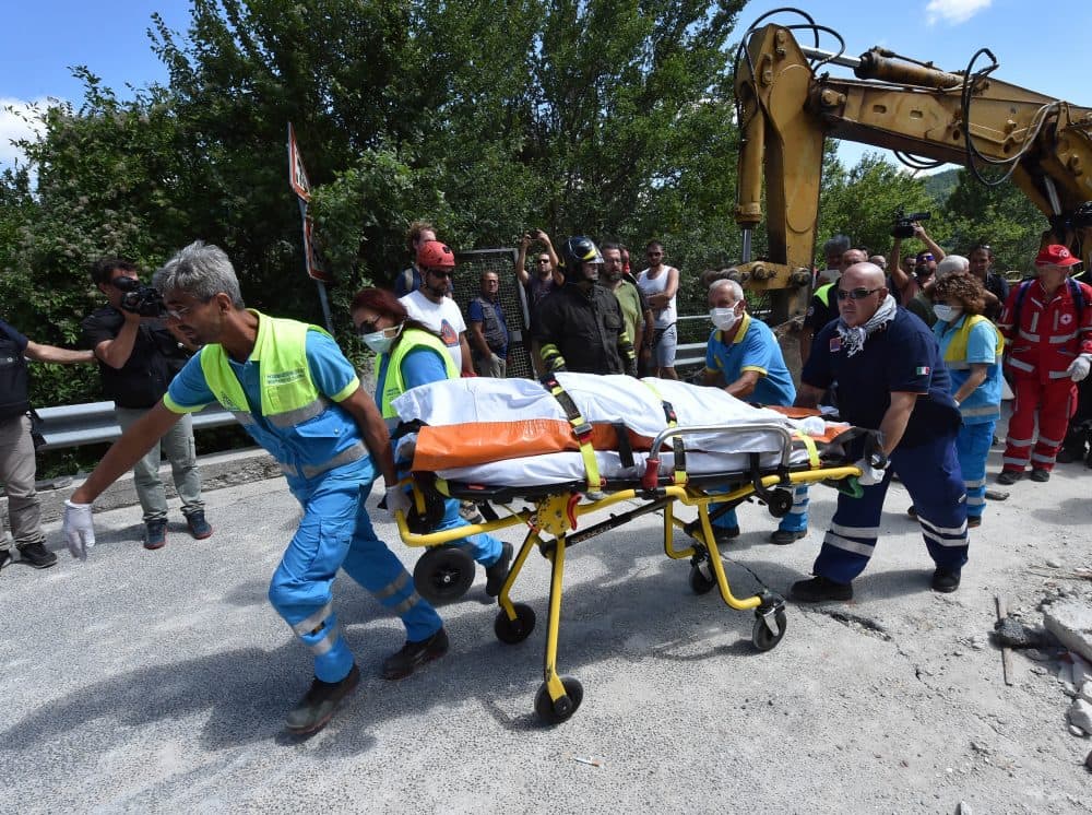 Rescue workers retrieve a dead body in a damaged building on Aug. 24, 2016 in Accumoli, Italy. (Giuseppe Bellini/Getty Images)