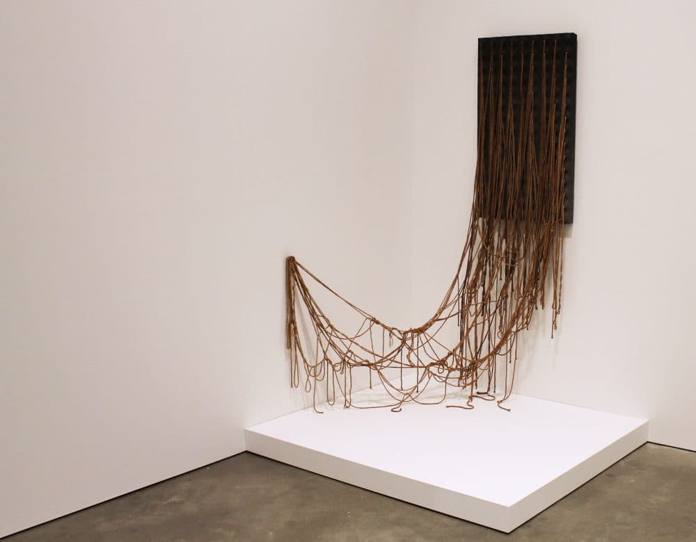The late Eva Hesse created &quot;Ennead&quot; in 1966 pushing the minimalist style of her time forward to a contemporary mindset. The piece uses geometric forms and industrial materials, but also activates the architecture of the room. (Amy Gorel for WBUR) 