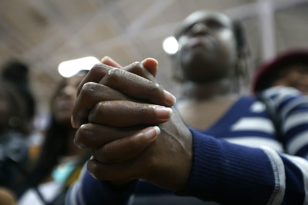 An audience member clasps her hands as she listens to Democratic presidential candidate Hillary Clinton speak at a "Get Out The Vote" rally for historically black colleges and universities, at South Carolina State University in Orangeburg, S.C. on Feb. 26, 2016. (Gerald Herbert/AP)