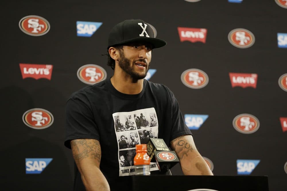 Colin Kaepernick has drawn criticism for sitting during the national anthem. (Ben Margot/AP)