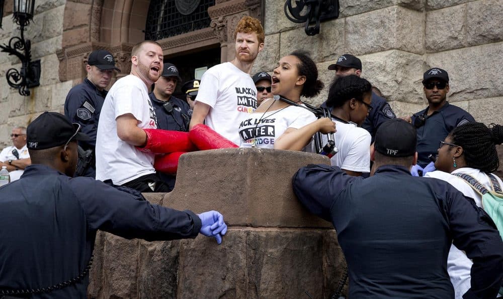 Black Lives Matter protesters linked together outside Cambridge City Hall Wednesday morning. (Robin Lubbock/WBUR)