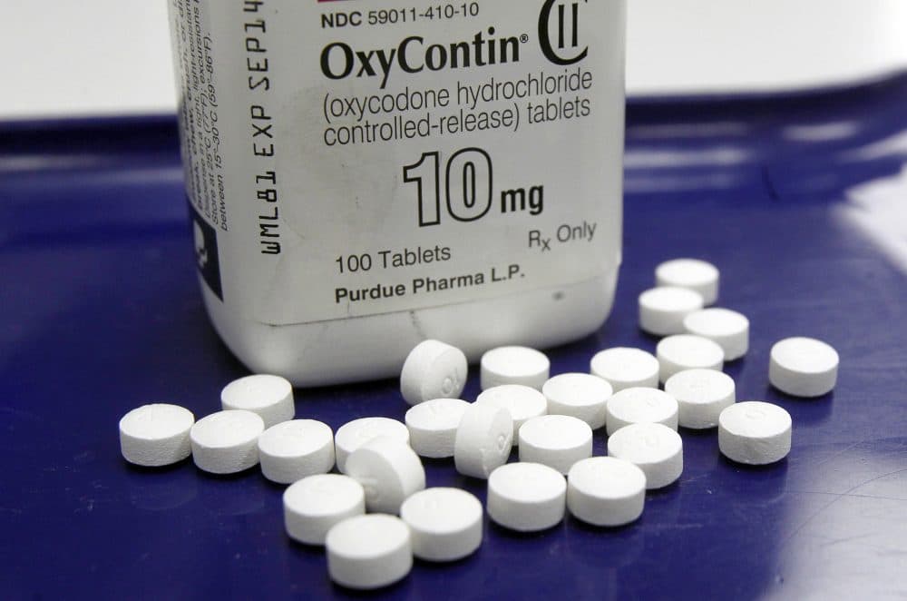 Kingsley Iyare Osemwengie, who operated in many states including Massachusetts, used call girls and couriers to transport oxycodone, and then shifted profits through an anonymous shell company named High Profit Investments LLC. This Feb. 19, 2013 photo shows OxyContin pills arranged at a pharmacy in Montpelier, Vt. (Toby Talbot/AP)