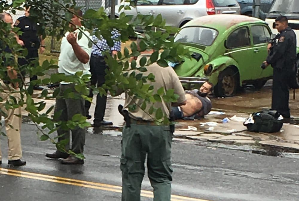 Ahmad Khan Rahami is taken into custody after a shootout with police Monday, Sept. 19, 2016, in Linden, N.J. Rahami was wanted for questioning in the bombings that rocked the Chelsea neighborhood of New York and the New Jersey shore town of Seaside Park. (Moshe Weiss via AP)