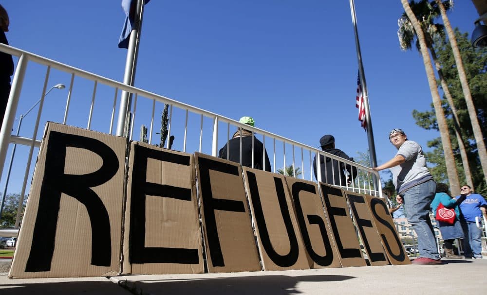 A sign welcoming Syrian refugees is placed at the entrance to the office of the Arizona governor during a rally at the Arizona Capitol Tuesday, Nov. 17, 2015, in Phoenix. The Syrian civil war, which has produced nearly 5 million refugees and internally displaced millions more, drove Bassam Al Abbas and his family from their home. They eventually settled in Austin, Texas. (Ross D. Franklin/AP)