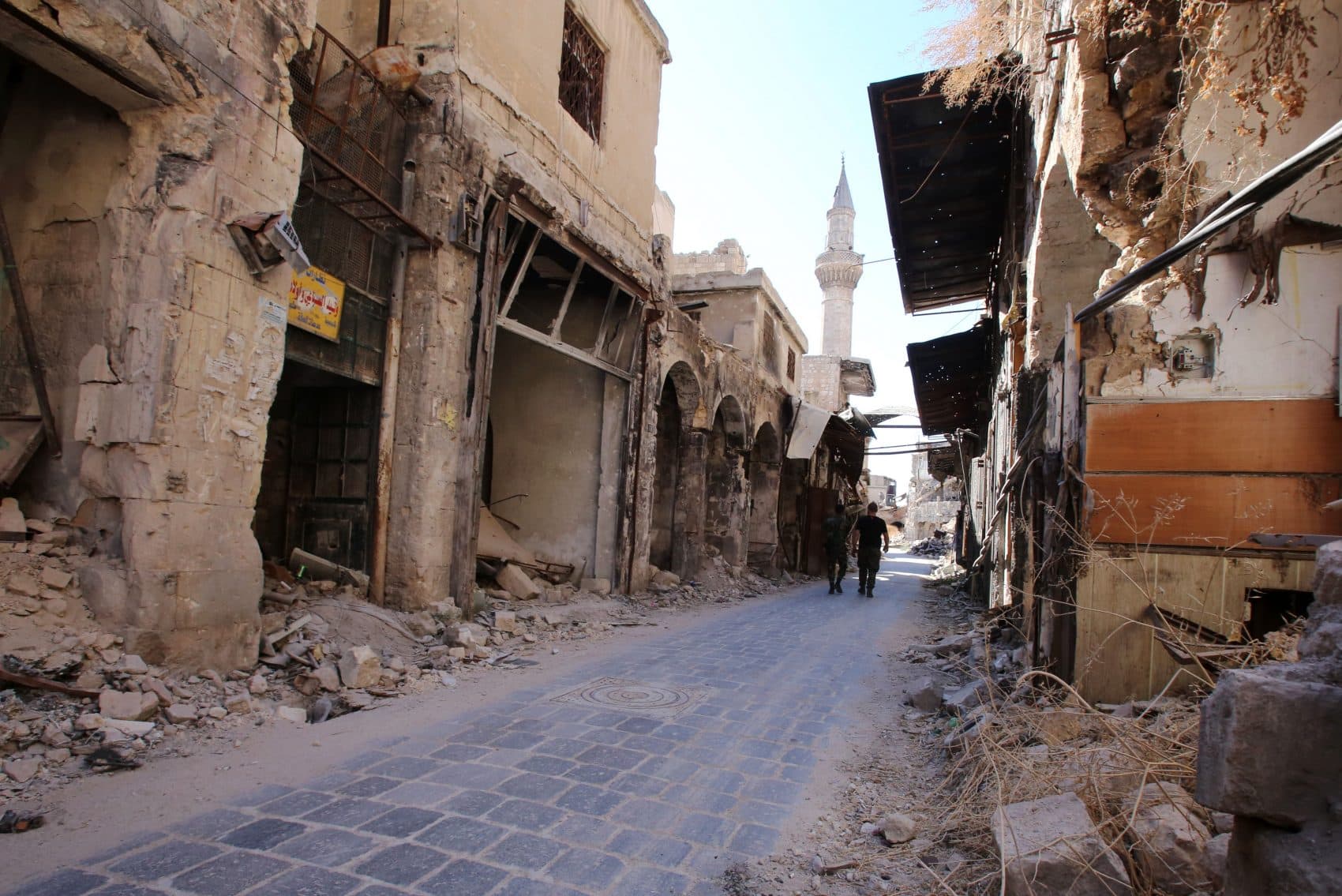 Syrian government soldiers walk in the damaged al-Farafira souk in the government-held side of Aleppo's historic city center on Sept. 16, 2016. (Youssef Karwashan/AFP/Getty Images)