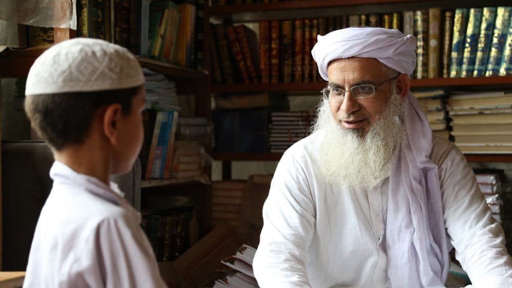 Pakistani cleric Abdul Aziz Ghazi (right), in a still frame from the documentary "Among the Believers." (Courtesy)