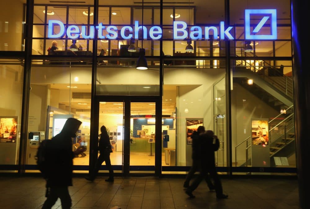 People walk past a branch of Deutsche Bank on Feb. 9, 2016 in Berlin, Germany. The Justice Department asked the bank to pay $14 billion to settle an investigation into risky mortgage practices leading up to the financial crisis. (Sean Gallup/Getty Images)