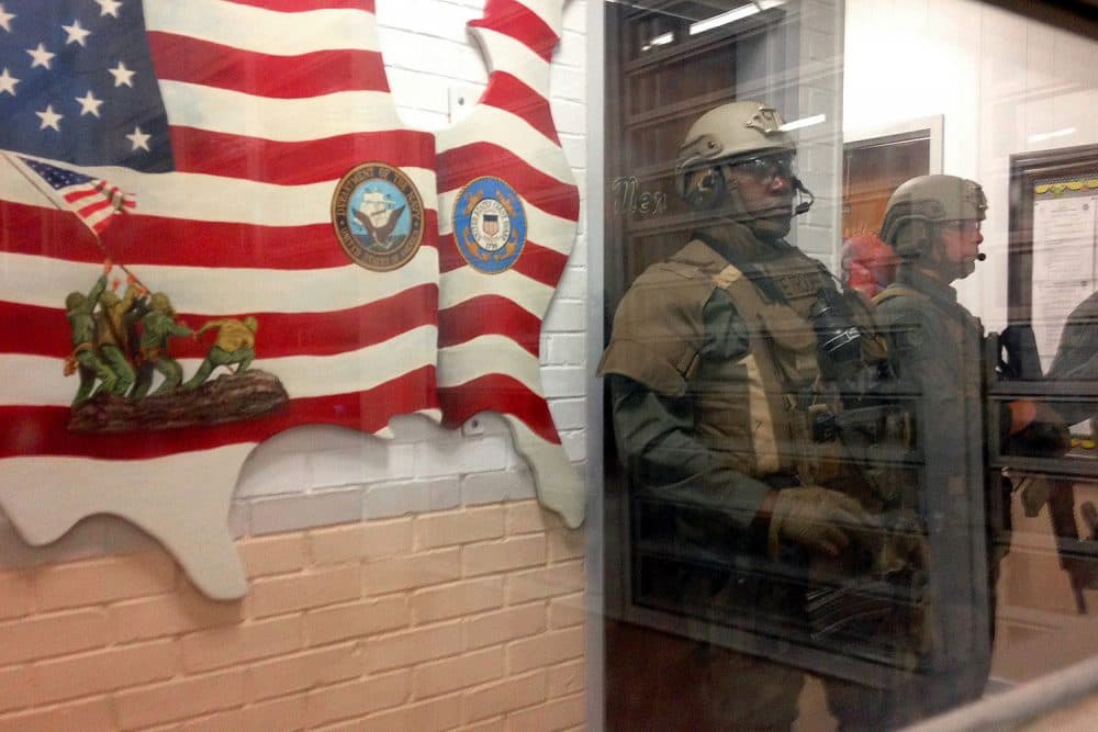 Armed state troopers are seen through a window as they accompany Alabama Gov. Robert Bentley inside Holman prison in Atmore, Ala., on Tuesday, March 15, 2016. (Melissa Brown/AP)