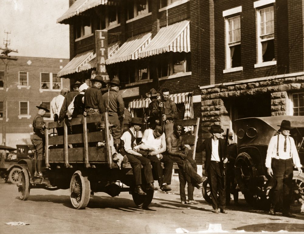 Injured and wounded prisoners are taken to hospital by National Guardsmen after martial law was declared in Tulsa, Okla., after the race riots in June 1921. (Hulton Archive/Getty Images)