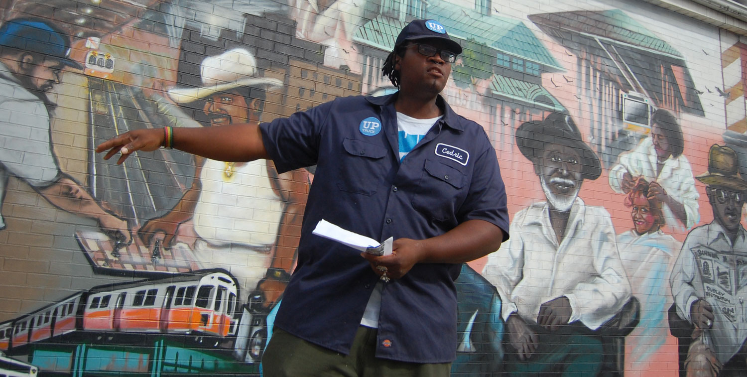 Cedric Douglas at the "Faces of Dudley" mural in Roxbury. (Greg Cook)
