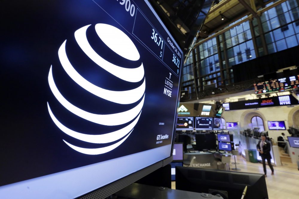 The AT&T logo appears above the post where it trades on the floor of the New York Stock Exchange, Monday, Oct. 24, 2016. AT&T's $85.4 billion purchase of Time Warner represents a new bet on synergy between companies that distribute information and entertainment to consumers and those that produce it. (Richard Drew/AP)