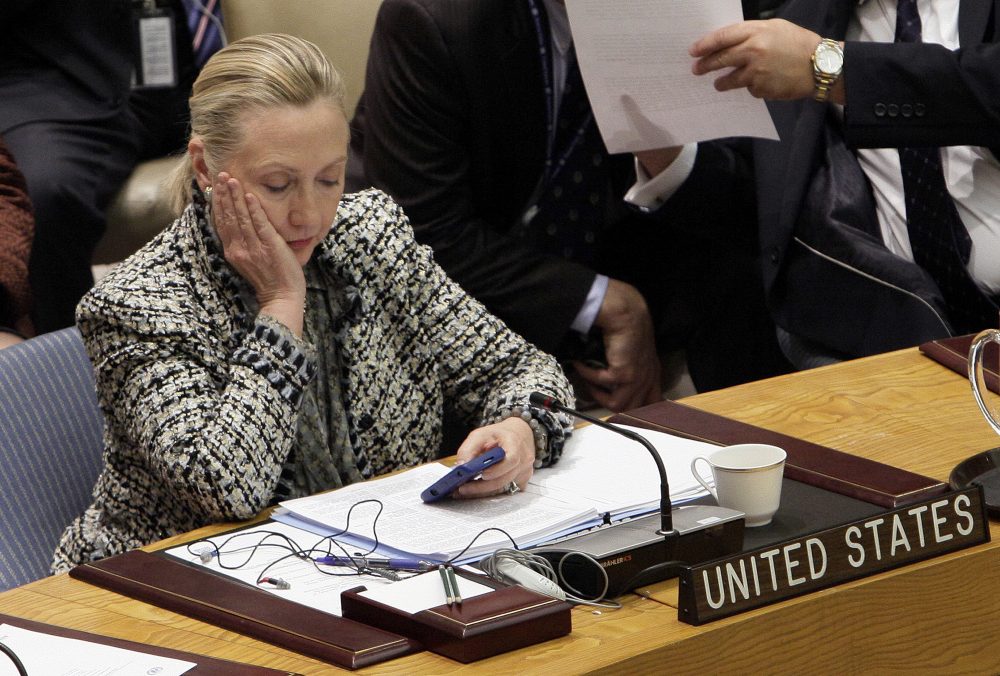 In this March 12, 2012, file photo, then-Secretary of State Hillary Clinton checks her mobile phone after her address to the Security Council at United Nations headquarters. (Richard Drew/AP)