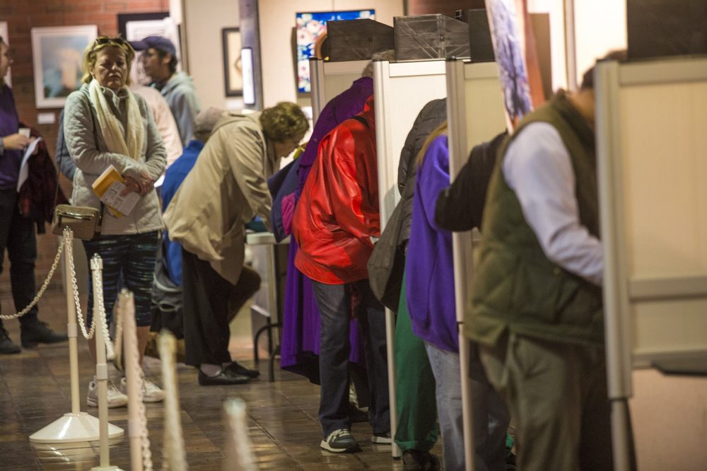 Voters fill out ballots in Boston on Monday, October 24, the first day of early voting in the state. (Jesse Costa/WBUR)