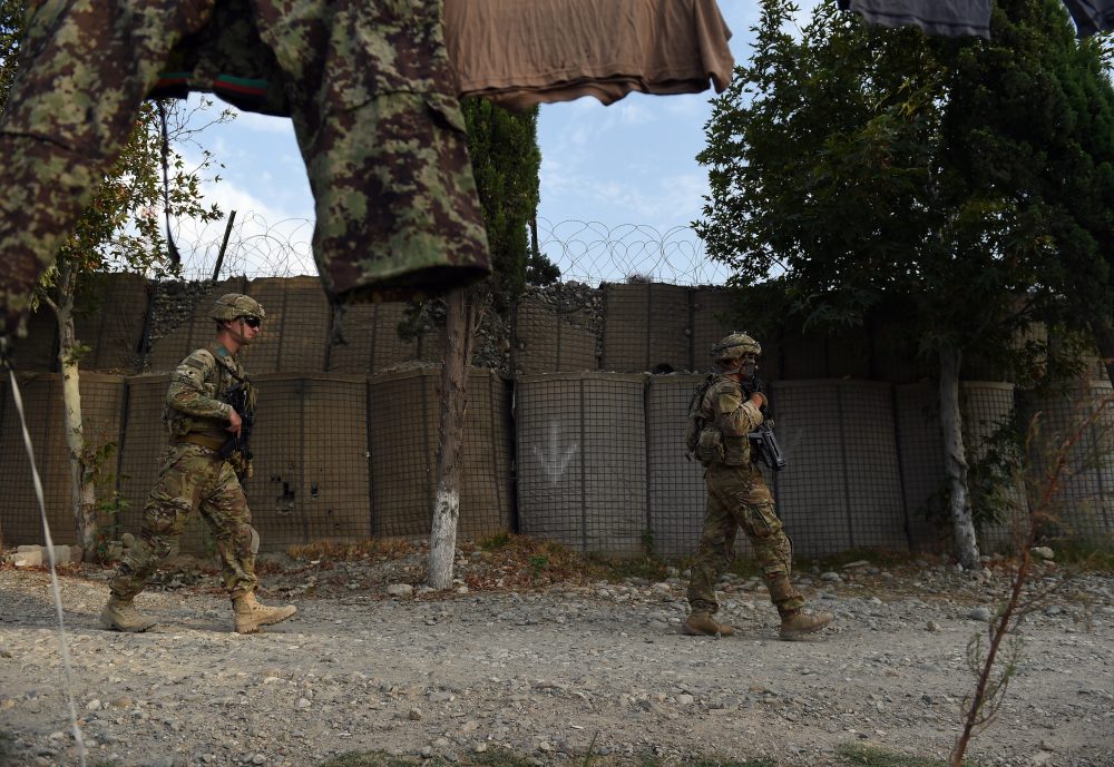 In this 2015 photograph, U.S. soldiers walk past an Afghan National Army base in the Khogyani district in the eastern province of Nangarhar. (Wakil Kohsar/AFP/Getty Images)