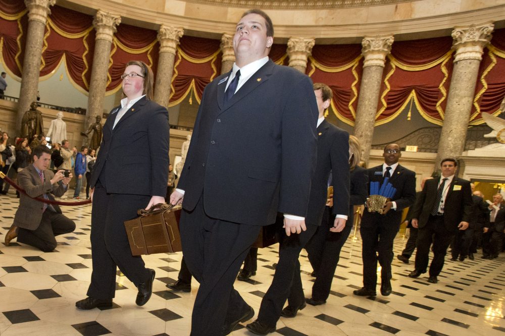 Pages lead a Senate procession carrying two boxes holding Electoral College votes through Statuary Hall to the House Chamber on Capitol Hill in Washington, Friday, Jan. 4, 2013, for the counting of the votes in the presidential election. (Jacquelyn Martin/AP)