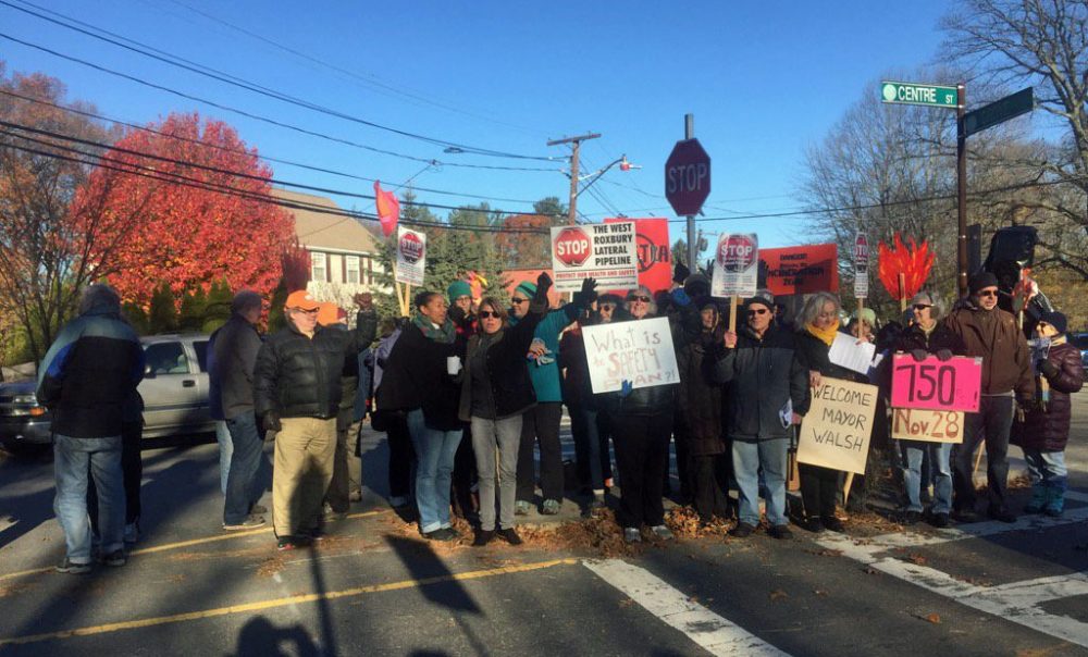 For nearly two years local activists have gathered along Centre Street in West Roxbury -- some every day -- in an effort to prevent Spectra Energy from building a natural gas pipeline through the neighborhood. Here, opponents gather Wednesday after finding out Spectra planned to start the flow of gas through the pipeline on Dec. 1. (Bruce Gellerman/WBUR)