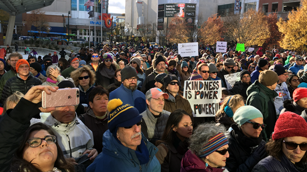 A crowd gathers for an interfaith rally Sunday outside the Silver Spring Civic Center to protest a surge in hate incidents in the county. Some local authorities say despite anti-immigration rhetoric from the incoming Trump administration, they don't plan to enforce strict immigration laws. (Armando Trull/WAMU)