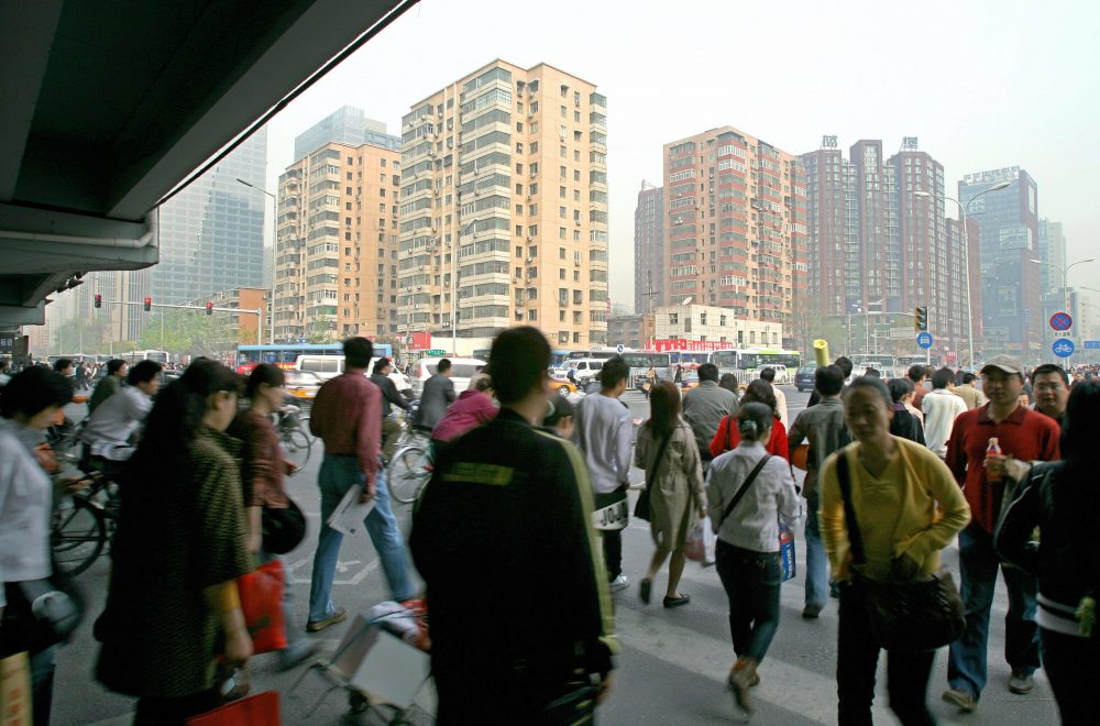 A busy street scene shows a crowd of people rushing to work in central Beijing, April 19, 2007. Beijing's local government is among the three dozen beginning to collect data to rate creditworthiness. (Teh Eng Koon/AFP/Getty Images)